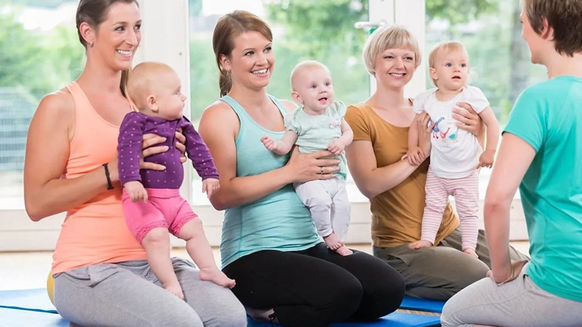 Mothers Holding their babies in Parenting Class